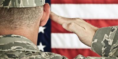 Military soldier saluting an American flag